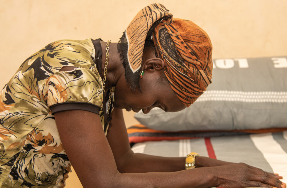 Nigerian Widow and Children Seek Refuge After Village Attacked Nigerian Widow prays